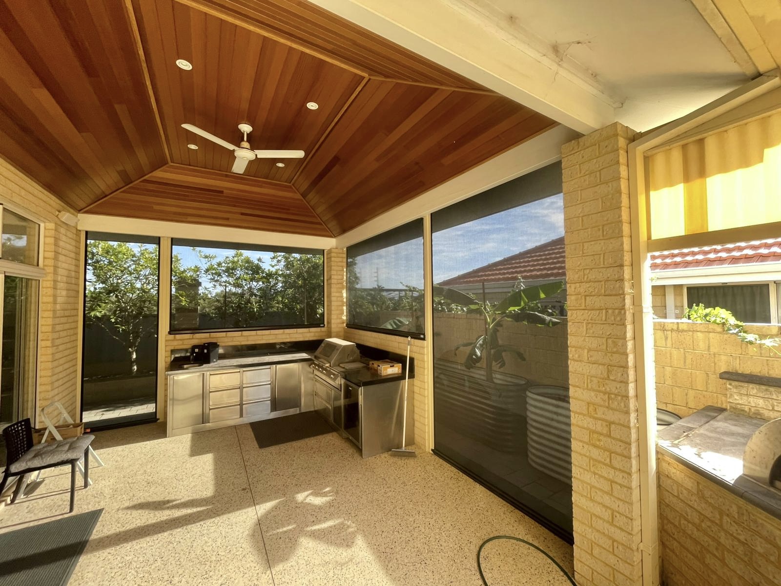 Ziptrak blinds on timber-lined outdoor entertaining area with BBQ, Perth