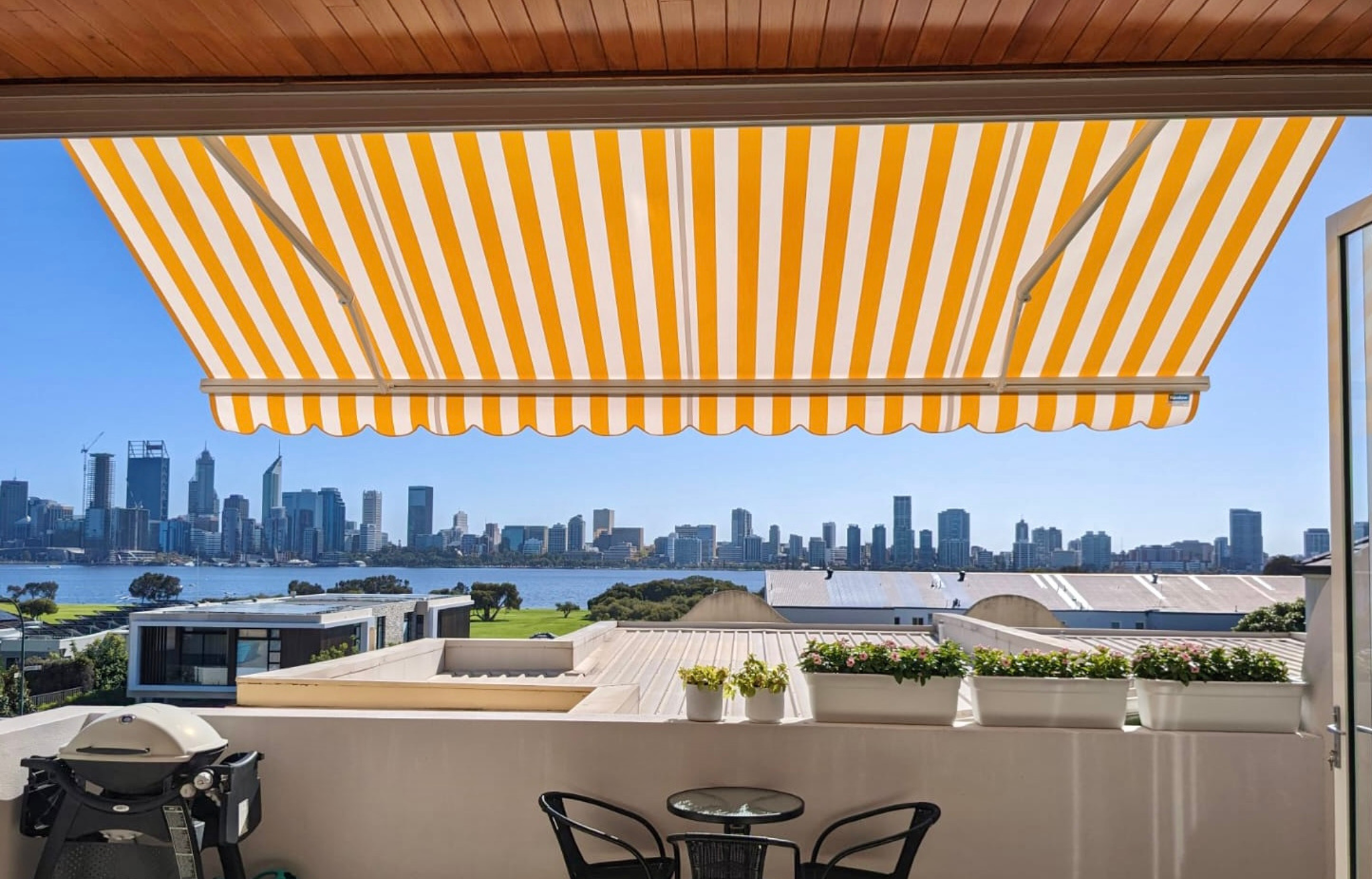 Retractable folding arm awning over a Perth outdoor entertaining area with views