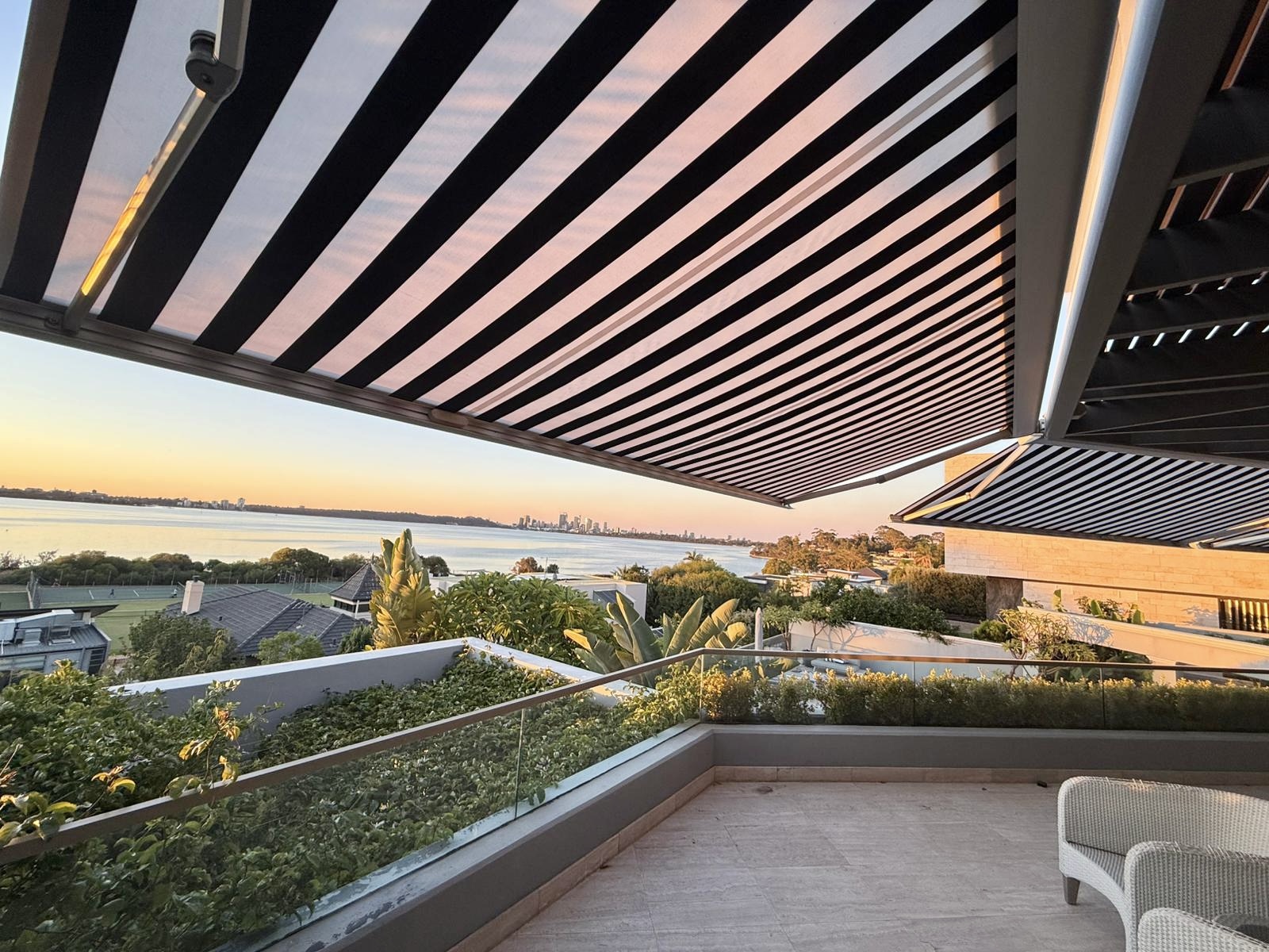 Retractable folding arm awning on a balcony overlooking the Swan River in Perth