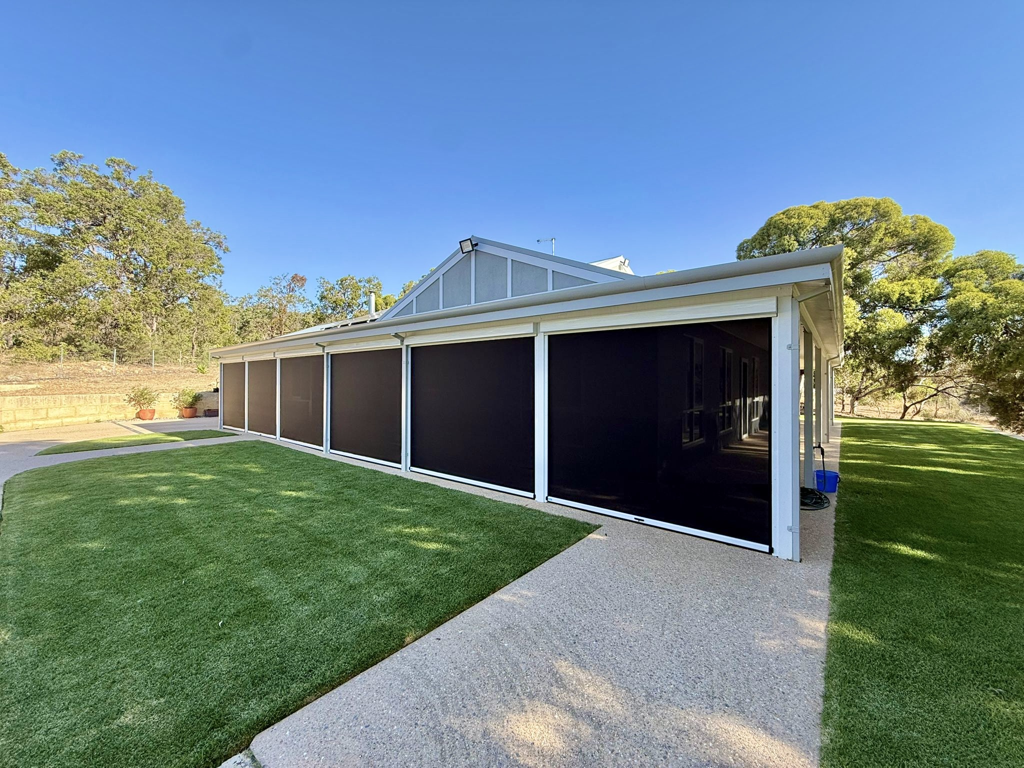 Mesh outdoor blinds providing sun and UV protection on a Perth patio