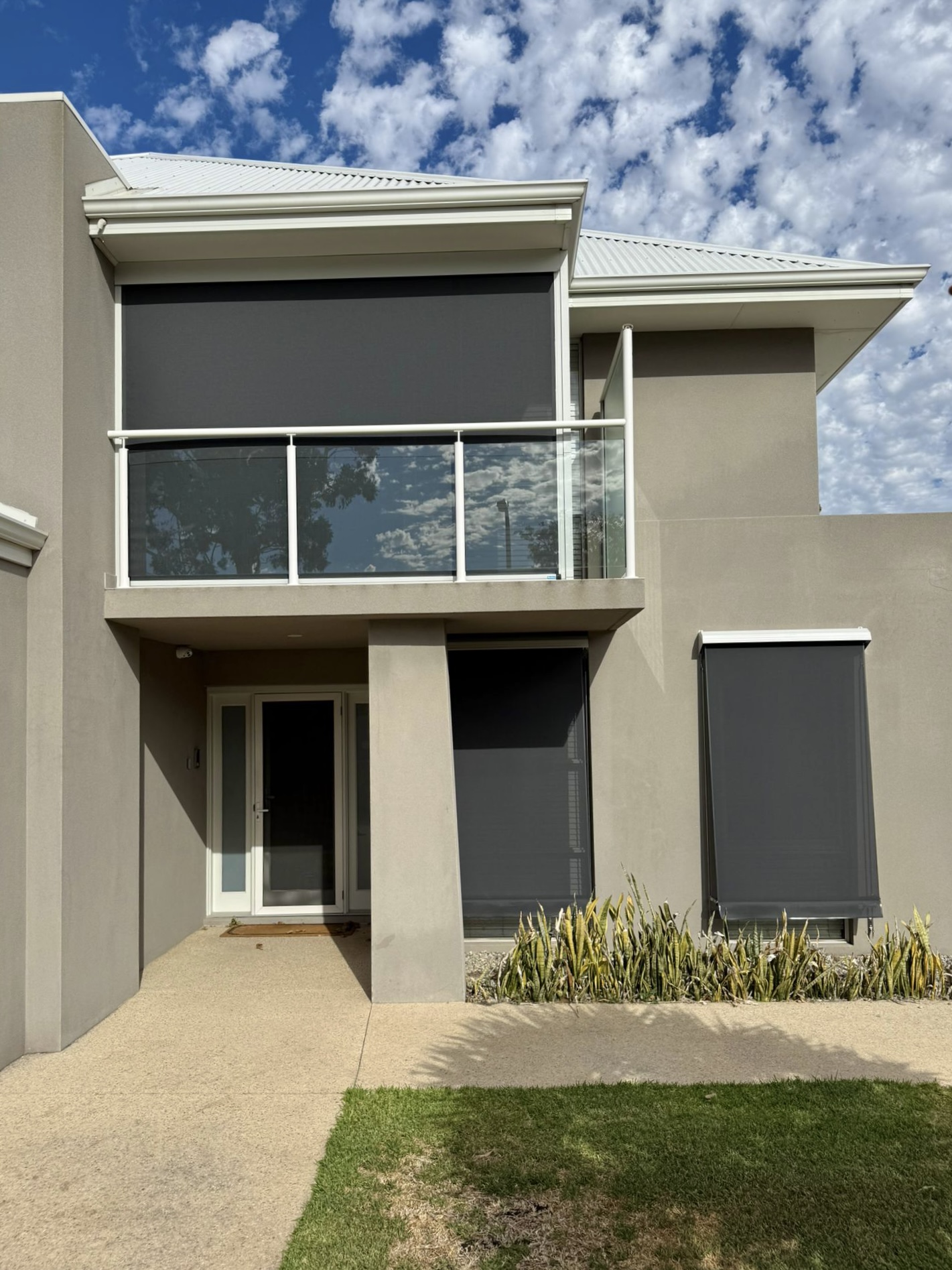 Charcoal mesh outdoor blinds on a modern two-storey Perth home for sun and glare control
